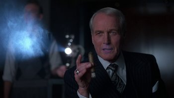 Movie still from “The Hudsucker Proxy” (1994), directed by Ethan Coen – A man holding a cigar in his hand; Close Up shot, Low angle