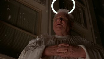 Movie still from “The Hudsucker Proxy” (1994), directed by Ethan Coen – An old man with a halo around his head; Close Up shot, Low angle