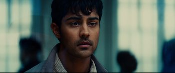 Movie still from “The Hundred-Foot Journey” (2014), directed by Lasse Hallström – A person wearing a suit and tie; Close Up shot, Over the shoulder angle