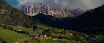 Movie still from “The Hundred-Foot Journey” (2014), directed by Lasse Hallström – A view of a mountain valley with a church in the foreground; Extreme Wide shot, High angle