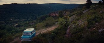 Movie still from “The Hundred-Foot Journey” (2014), directed by Lasse Hallström – A van is driving down a dirt road in the middle of a valley; Extreme Wide shot, High angle