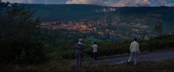 Movie still from “The Hundred-Foot Journey” (2014), directed by Lasse Hallström – Two men standing on a hill overlooking a town; Extreme Wide shot, High angle