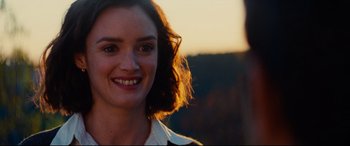Movie still from “The Hundred-Foot Journey” (2014), directed by Lasse Hallström – A woman smiling for the camera; Close Up shot, Over the shoulder angle