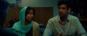 Movie still from “The Hundred-Foot Journey” (2014), directed by Lasse Hallström – A man and a woman sitting next to each other in a room; Medium shot, Over the shoulder angle