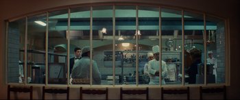 Movie still from “The Hundred-Foot Journey” (2014), directed by Lasse Hallström – A group of people standing in a restaurant kitchen; Wide shot, Over the shoulder angle