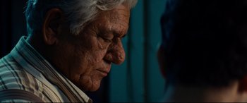 Movie still from “The Hundred-Foot Journey” (2014), directed by Lasse Hallström – An old man with a white beard is looking down at his face; Close Up shot, Over the shoulder angle