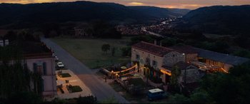 Movie still from “The Hundred-Foot Journey” (2014), directed by Lasse Hallström – An aerial view of a house at night with lights; Extreme Wide shot, High angle