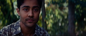 Movie still from “The Hundred-Foot Journey” (2014), directed by Lasse Hallström – A man's face in front of trees; Close Up shot, High angle