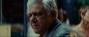 Movie still from “The Hundred-Foot Journey” (2014), directed by Lasse Hallström – An older man with white hair looking at the camera; Close Up shot, Over the shoulder angle