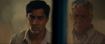 Movie still from “The Hundred-Foot Journey” (2014), directed by Lasse Hallström – A man's face in front of an older man's face; Close Up shot, Over the shoulder angle