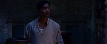 Movie still from “The Hundred-Foot Journey” (2014), directed by Lasse Hallström – A man in a white shirt is looking up; Medium shot, Over the shoulder angle