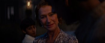 Movie still from “The Hundred-Foot Journey” (2014), directed by Lasse Hallström – A person smiling for the camera; Close Up shot, Over the shoulder angle