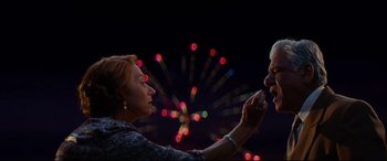 Movie still from “The Hundred-Foot Journey” (2014), directed by Lasse Hallström – A man and a woman holding hands in front of a fireworks display; Close Up shot, Low angle