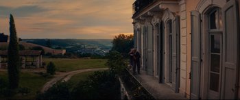 Movie still from “The Hundred-Foot Journey” (2014), directed by Lasse Hallström – Two people standing on a porch of a house; Extreme Wide shot, Low angle