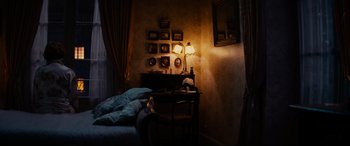 Movie still from “The Hundred-Foot Journey” (2014), directed by Lasse Hallström – A bed room with a bed and a table with a lamp on it; Wide shot, High angle