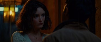 Movie still from “The Hundred-Foot Journey” (2014), directed by Lasse Hallström – A young woman looking at a man in a dark room; Close Up shot, Over the shoulder angle