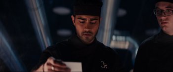 Movie still from “The Hundred-Foot Journey” (2014), directed by Lasse Hallström – A man looking at a piece of paper in his hand; Close Up shot, Over the shoulder angle