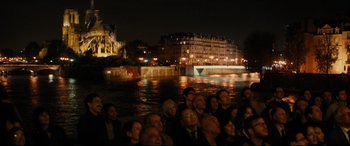 Movie still from “The Hundred-Foot Journey” (2014), directed by Lasse Hallström – A group of people sitting in front of a body of water at night; Extreme Wide shot, High angle