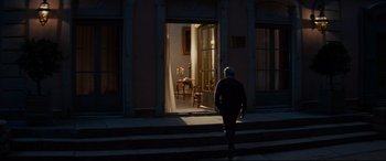 Movie still from “The Hundred-Foot Journey” (2014), directed by Lasse Hallström – An old man walking down the steps in front of an open door; Wide shot, High angle