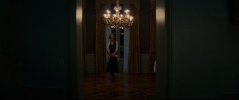 Movie still from “The Hundred-Foot Journey” (2014), directed by Lasse Hallström – A woman standing in front of a chandelier in a room; Wide shot, Low angle