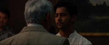 Movie still from “The Hundred-Foot Journey” (2014), directed by Lasse Hallström – A man standing next to another man in front of a mirror; Close Up shot, Over the shoulder angle