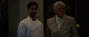 Movie still from “The Hundred-Foot Journey” (2014), directed by Lasse Hallström – A man and a man standing next to each other; Medium shot, Over the shoulder angle
