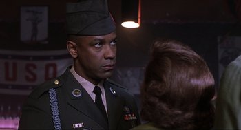 Movie still from “The Hurricane” (1999), directed by Norman Jewison – A man in a military uniform talking to a woman; Close Up shot, Over the shoulder angle