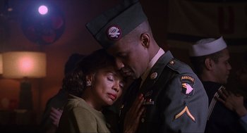 Movie still from “The Hurricane” (1999), directed by Norman Jewison – A man and a woman in military uniforms; Close Up shot, Low angle