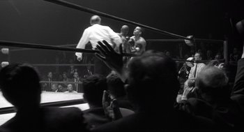 Movie still from “The Hurricane” (1999), directed by Norman Jewison – A crowd of people in a boxing ring watching; Wide shot, High angle