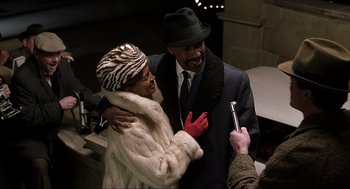 Movie still from “The Hurricane” (1999), directed by Norman Jewison – A man and a woman posing for a picture; Medium shot, Over the shoulder angle