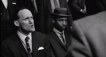 Movie still from “The Hurricane” (1999), directed by Norman Jewison – A black and white photo of two men in suits and hats; Medium shot, Over the shoulder angle