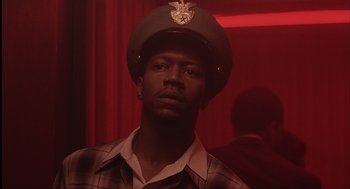 Movie still from “The Hurricane” (1999), directed by Norman Jewison – A man wearing a hat and a plaid shirt; Close Up shot, Low angle
