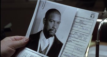 Movie still from “The Hurricane” (1999), directed by Norman Jewison – A person holding a picture of a man; Close Up shot, High angle