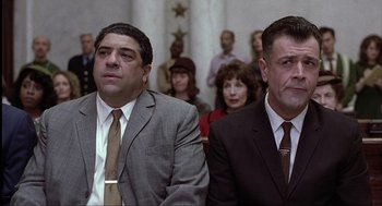 Movie still from “The Hurricane” (1999), directed by Norman Jewison – A couple of men sitting next to each other in front of a crowd; Close Up shot, Low angle