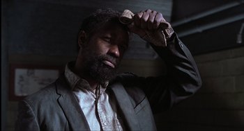 Movie still from “The Hurricane” (1999), directed by Norman Jewison – A man with a beard is combing his hair; Close Up shot, Low angle