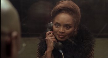 Movie still from “The Hurricane” (1999), directed by Norman Jewison – A woman talking on a phone while wearing a fur coat; Close Up shot, Over the shoulder angle