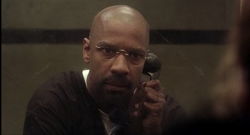 Movie still from “The Hurricane” (1999), directed by Norman Jewison – A man with a bald head talking on a cell phone; Close Up shot, High angle