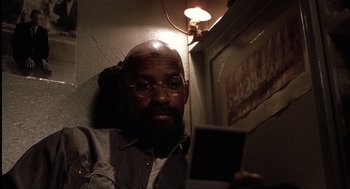 Movie still from “The Hurricane” (1999), directed by Norman Jewison – A man with a beard is holding a cell phone; Close Up shot, Over the shoulder angle