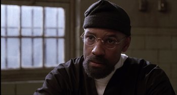 Movie still from “The Hurricane” (1999), directed by Norman Jewison – A man with a beard wearing glasses and a hat; Close Up shot, Low angle