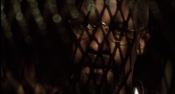Movie still from “The Hurricane” (1999), directed by Norman Jewison – A person wearing glasses; Extreme Close Up shot, Low angle