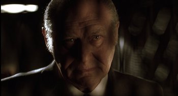 Movie still from “The Hurricane” (1999), directed by Norman Jewison – An old man with a beard and a suit and tie; Close Up shot, Low angle