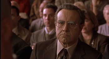 Movie still from “The Hurricane” (1999), directed by Norman Jewison – An older man wearing glasses and a suit and tie; Close Up shot, Low angle