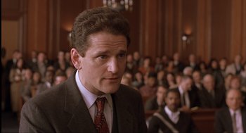 Movie still from “The Hurricane” (1999), directed by Norman Jewison – A person wearing a suit and tie in front of an audience; Close Up shot, Low angle