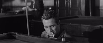Movie still from “The Hustler” (1961), directed by Robert Rossen – A black and white photo of a man smoking a cigarette; Close Up shot, Low angle