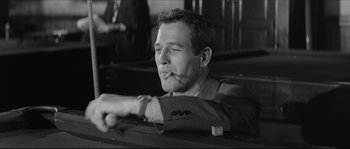 Movie still from “The Hustler” (1961), directed by Robert Rossen – A black and white photo of a man smoking a cigarette; Close Up shot, Low angle