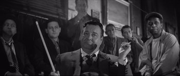 Movie still from “The Hustler” (1961), directed by Robert Rossen – Black and white photograph of a man in a suit and tie; Medium shot, Low angle