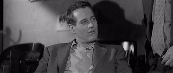 Movie still from “The Hustler” (1961), directed by Robert Rossen – Black and white photograph of a man smoking a cigarette; Close Up shot, Over the shoulder angle