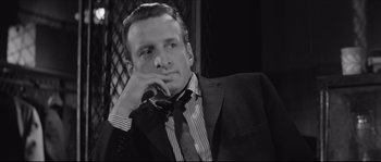 Movie still from “The Hustler” (1961), directed by Robert Rossen – A black and white photo of a man wearing a suit and tie; Close Up shot, Low angle