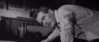 Movie still from “The Hustler” (1961), directed by Robert Rossen – Black and white photograph of a man leaning on a wall; Close Up shot, Low angle