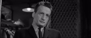 Movie still from “The Hustler” (1961), directed by Robert Rossen – A black and white photo of a man in a suit and tie; Close Up shot, Low angle